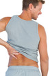 Foto: Man in tank top rubbing his back because of a back pain Man in tank top rubbing his back because of a back pain