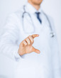 Photo: male doctor holding something in his hand male doctor holding something in his hand
