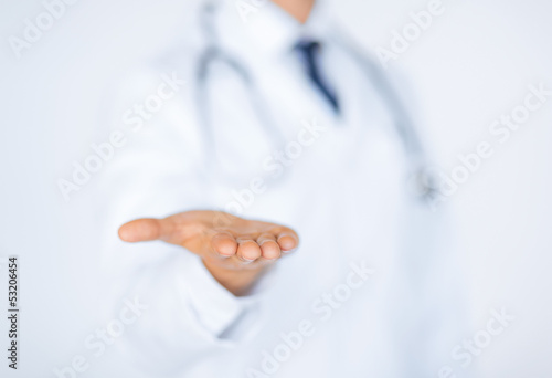Photo: male doctor holding something in his hand male doctor holding something in his hand