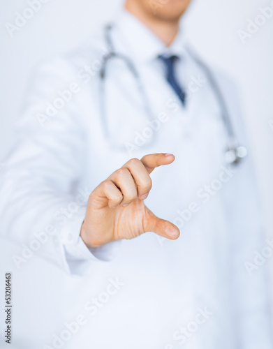 Photo: male doctor holding something in his hand male doctor holding something in his hand