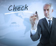 Businessman writing the word check