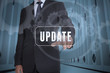 Foto: Businessman selecting a label with update written on it Businessman selecting a label with update written on it