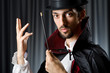 Magician in the dark room with wand