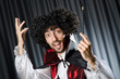 Magician in the dark room with wand