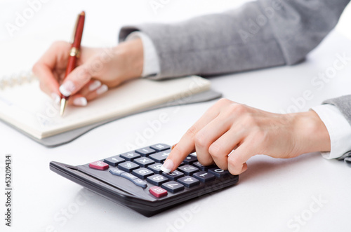 Photo: Hands working on the calculator Hands working on the calculator