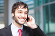 Photo: Handsome businessman talking on the phone Handsome businessman talking on the phone