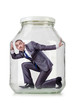 Young businessman in glass jar