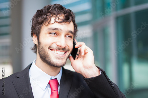 Photo: Handsome businessman talking on the phone Handsome businessman talking on the phone