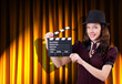 Woman gangster with movie clapper