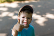 Little boy in cap victory sign