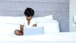 Child using laptop in bedroom