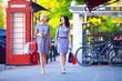 beautiful women walking the city street with shopping bags