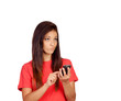 Photo: Attractive brunette girl dressed in red with a mobile thinking Attractive brunette girl dressed in red with a mobile thinking