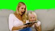Mother and her daughter using digital tablet in slow motion