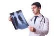 Young doctor with x-ray image on white