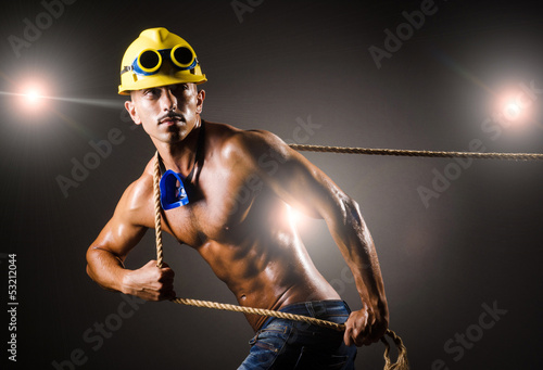 Photo: Nude builder pulling rope in darkness Nude builder pulling rope in darkness
