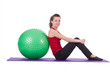Young woman with ball exercising on white