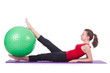Young woman with ball exercising on white