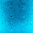 Blue water drops on glass