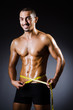 Muscular man measuring his muscles