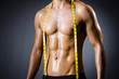Muscular man measuring his muscles