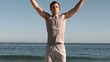 Handsome man jumping on a beach