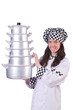 Cook with stack of pots on white