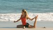 Woman stretching her leg on the beach