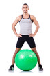 Man with swiss ball doing exercises on white
