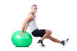 Photo: Man with swiss ball doing exercises on white Man with swiss ball doing exercises on white