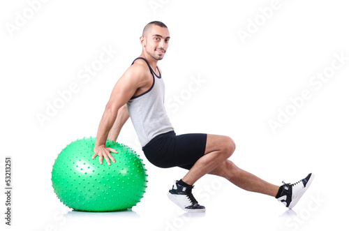 Photo: Man with swiss ball doing exercises on white Man with swiss ball doing exercises on white
