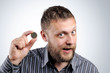 Photo: Businessman with a coin. The concept of saving Businessman with a coin. The concept of saving