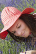 Photo: Young woman with hat in a lavender garden Young woman with hat in a lavender garden