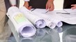 Close up of business people working on blueprints