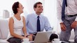 Businessman shaking hands of business people