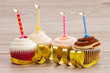 four birthday cupcakes on table