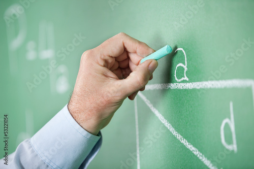 Photo: Mature Teacher'S Hand Writing Alphabet On Greenboard Mature Teacher'S Hand Writing Alphabet On Greenboard