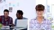 Cheerful designer posing while her colleagues are working