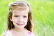 Cute smiling little girl on the meadow