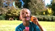 Cheerful young boy blowing into a bubble wand