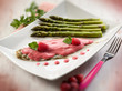 Photo: sole fish with raspberry cream and asparagus, selective focus sole fish with raspberry cream and asparagus, selective focus