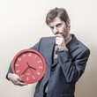 businessman with clock doubtful