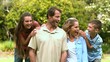 Video: Smiling family spending time together in a park Smiling family spending time together in a park
