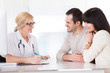 Happy Doctor Discussing With Couple