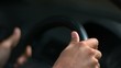 Hands of a man driving a car