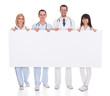Photo: Group Of Doctors With Placard Group Of Doctors With Placard