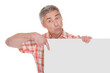 Photo: Happy Mature Man Holding Blank Placard Happy Mature Man Holding Blank Placard