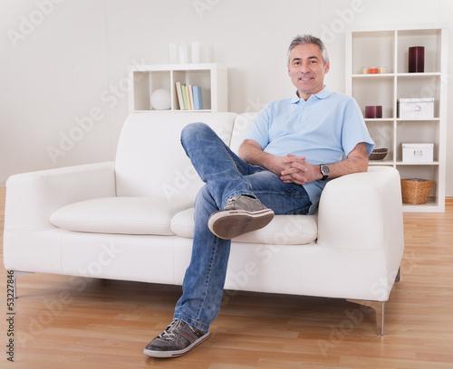 Photo: Mature Man Sitting On Sofa Mature Man Sitting On Sofa