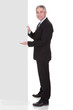 Photo: Mature Businessman Pointing At Placard Mature Businessman Pointing At Placard