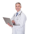 Photo: Portrait Of Male Doctor Using Laptop Portrait Of Male Doctor Using Laptop